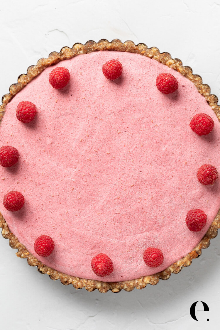 vegan cheesecake garnished with raspberries