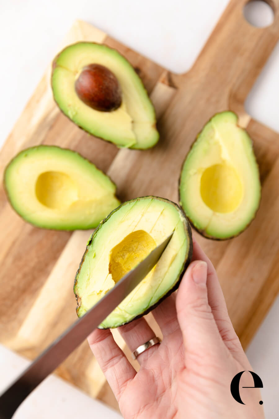 slicing an avocado with a knife