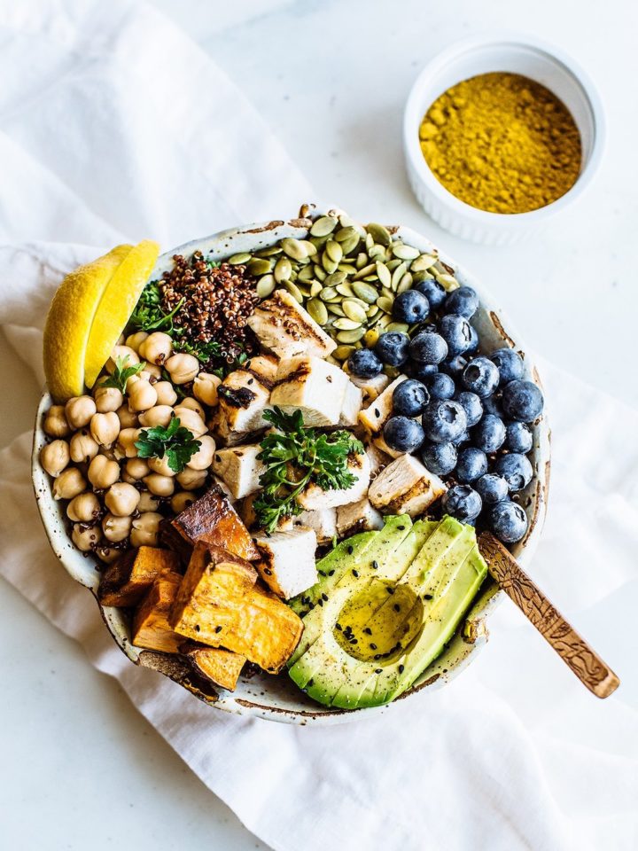 bowl with avocado, blueberries, salad, chickpeas and turmeric