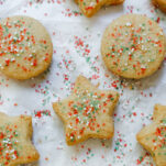 Almond Flour Shortbread Cookies with red and green sprinkles on white parchment paper