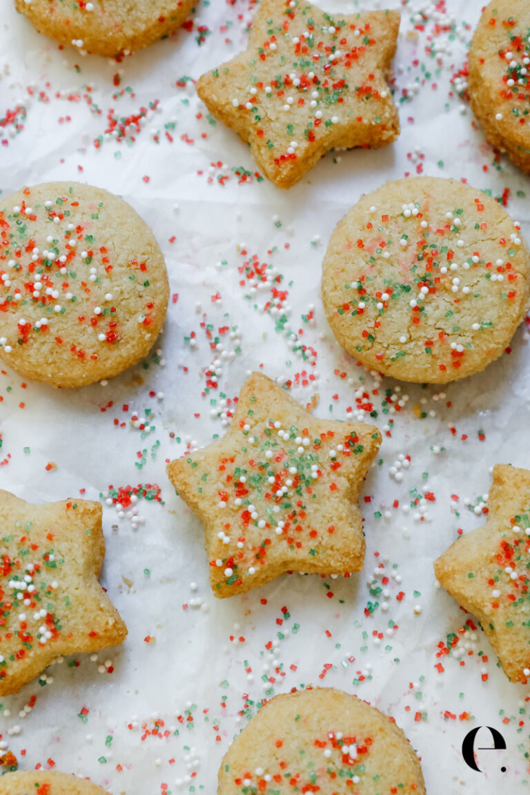 Almond Flour Shortbread Cookies with red and green sprinkles on white parchment paper