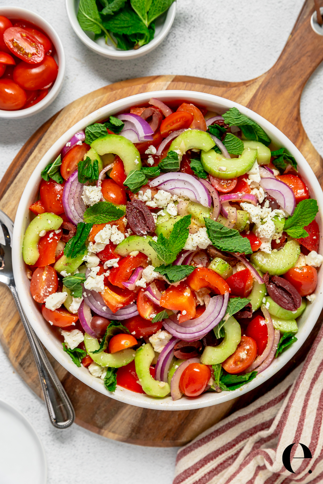 Greek salad with tomato cucumber mint onion and olive oil in bowl