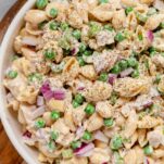 Homemade tuna pasta salad with a creamy dressing, peas, and red onion ready to enjoy