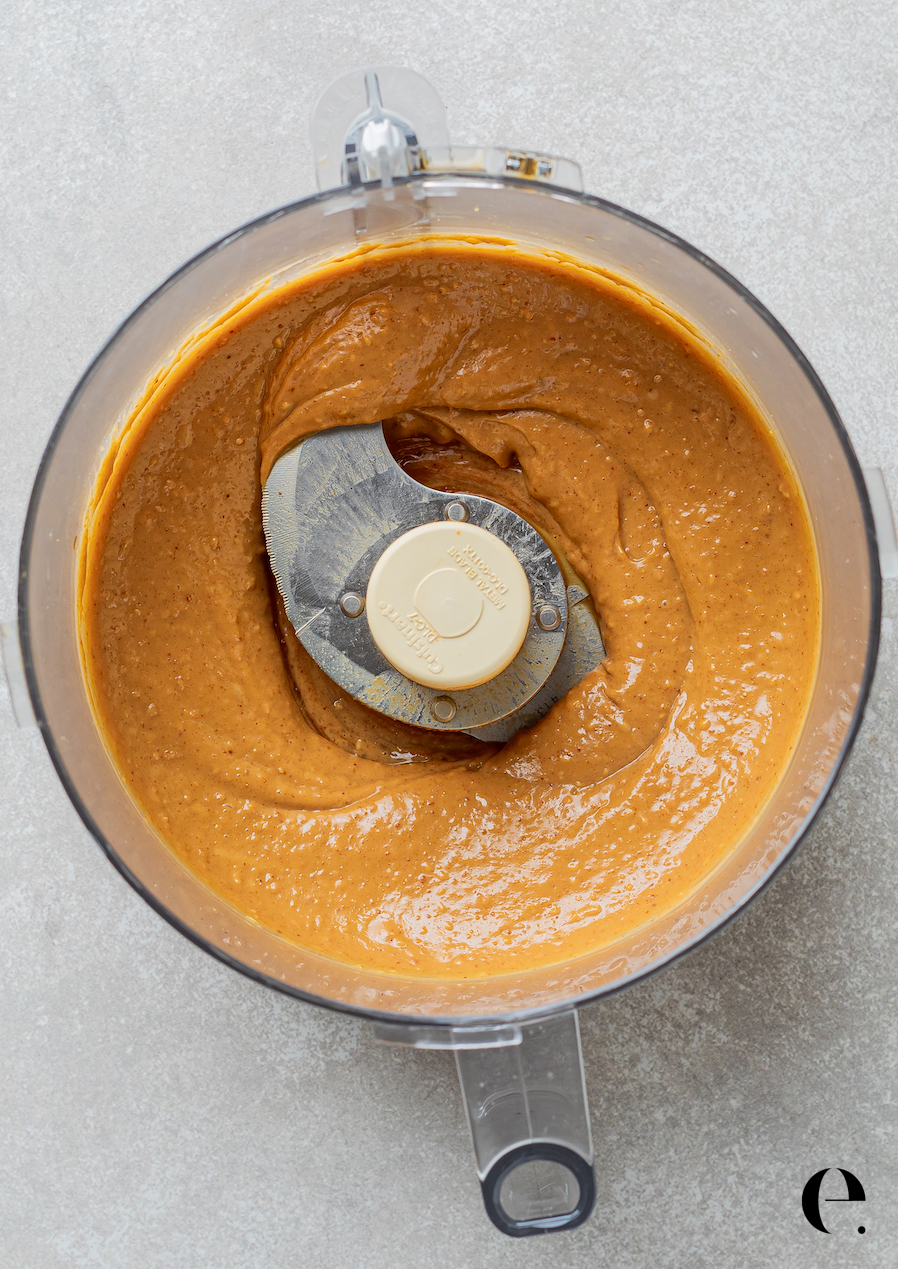 Homemade Thai peanut sauce blended in a food processor until smooth and creamy
