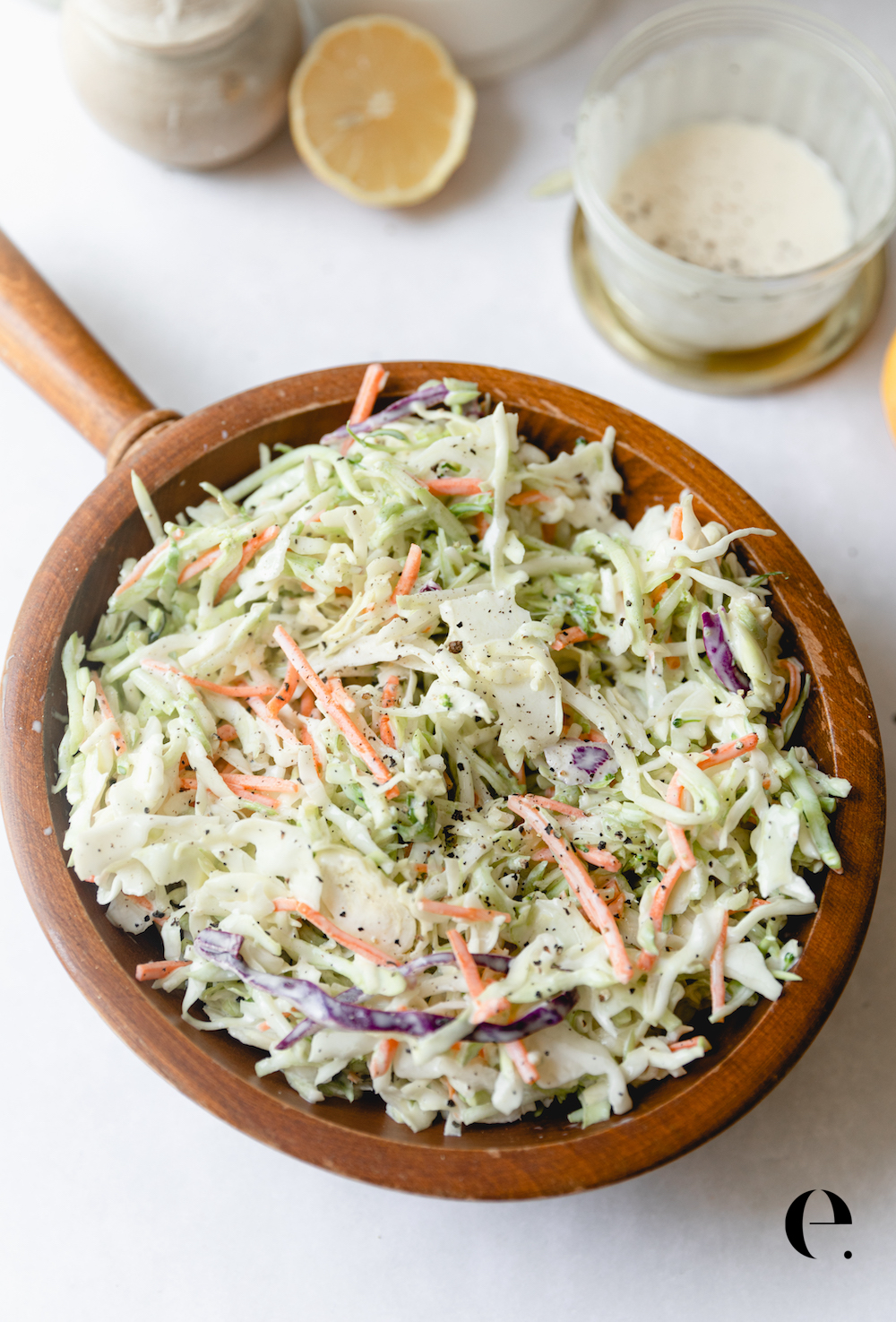 Easy Homemade Coleslaw Recipe with homemade dressing in wood bowl by Elizabeth Rider