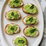Fava Bean Crostini with Ricotta on white plate by Mint Elizabeth Rider