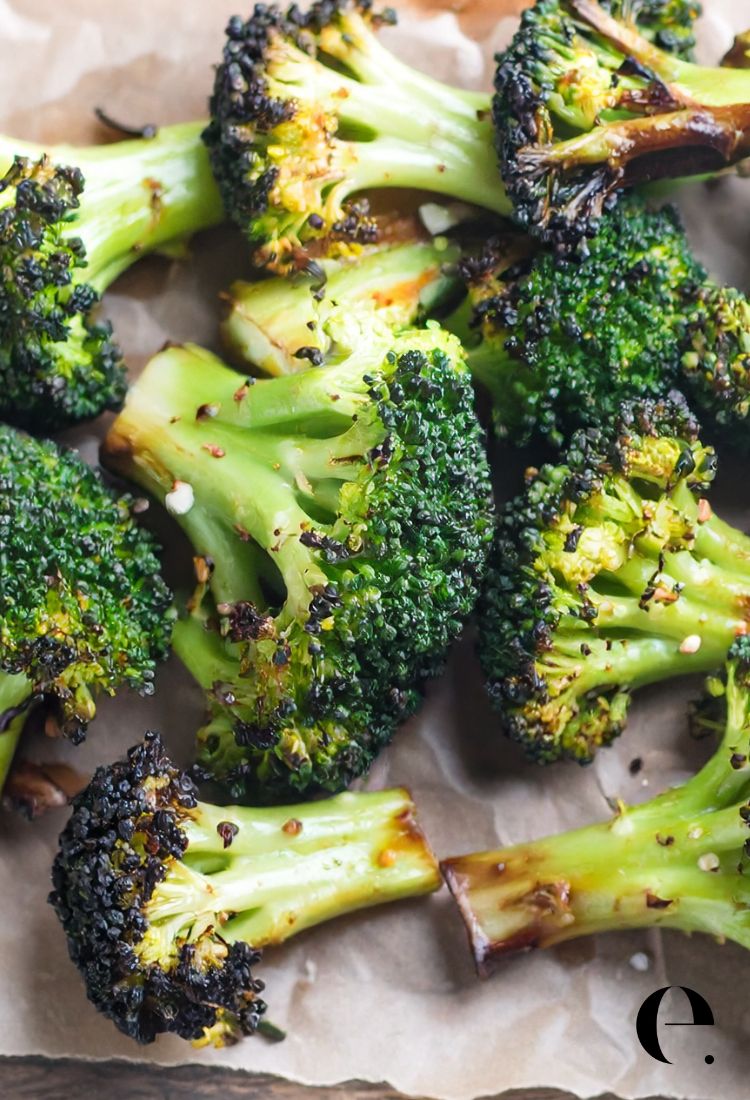 Roasted Broccoli florets with crispy edges on cutting board