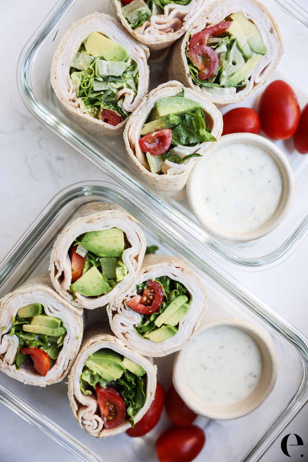 turkey avocado wrap sliced in half in glass meal prep containers with ranch dressing