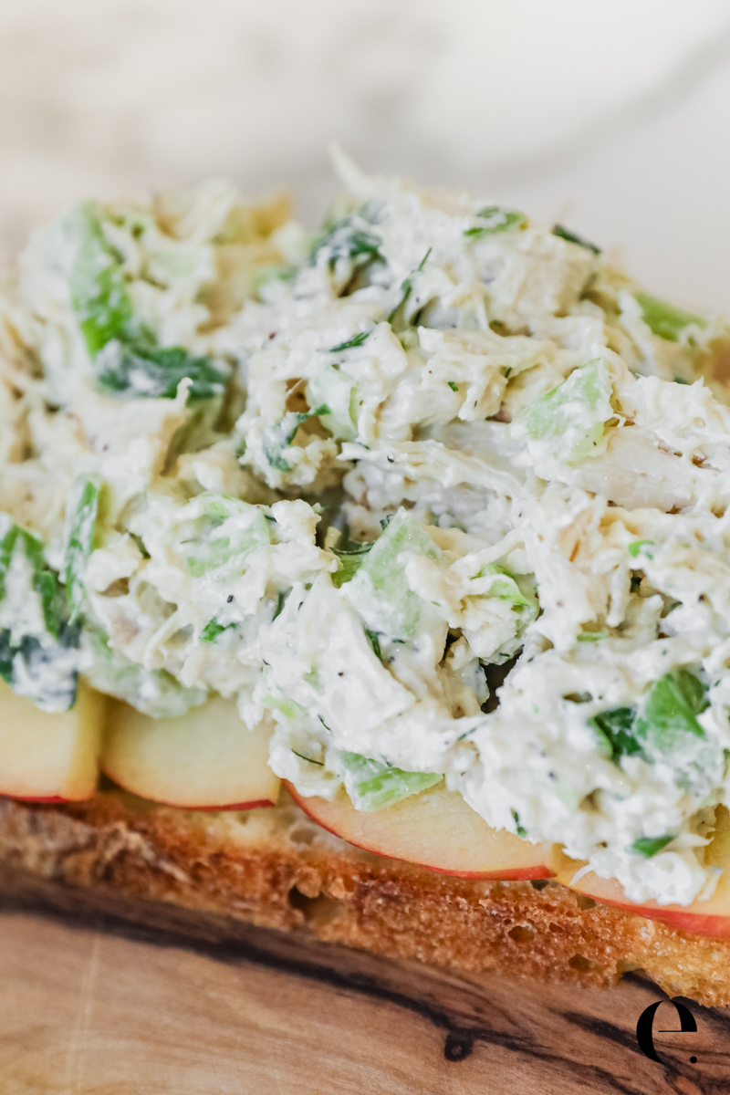 Classic chicken salad piled on bakery bread with thin apple slices, served open-face
