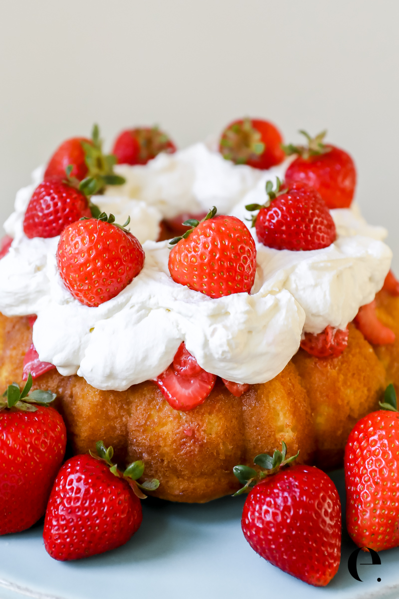 Easy Strawberry Shortcake with whipped cream and fresh strawberries on cake plate by Elizabeth Rider