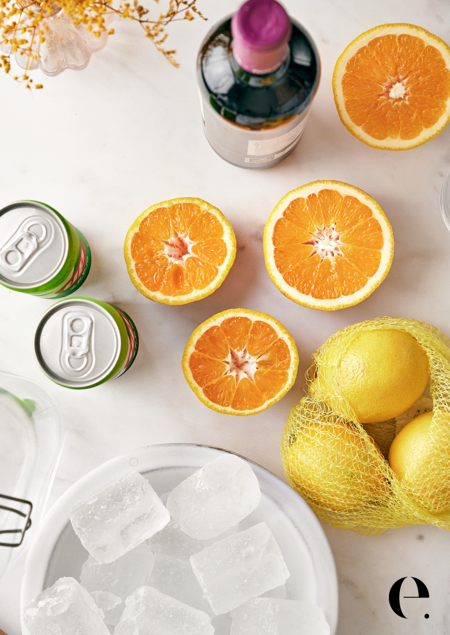 Tinto de verano ingredients: red wine, lemon-lime soda, sliced oranges and lemons, ice, and glasses