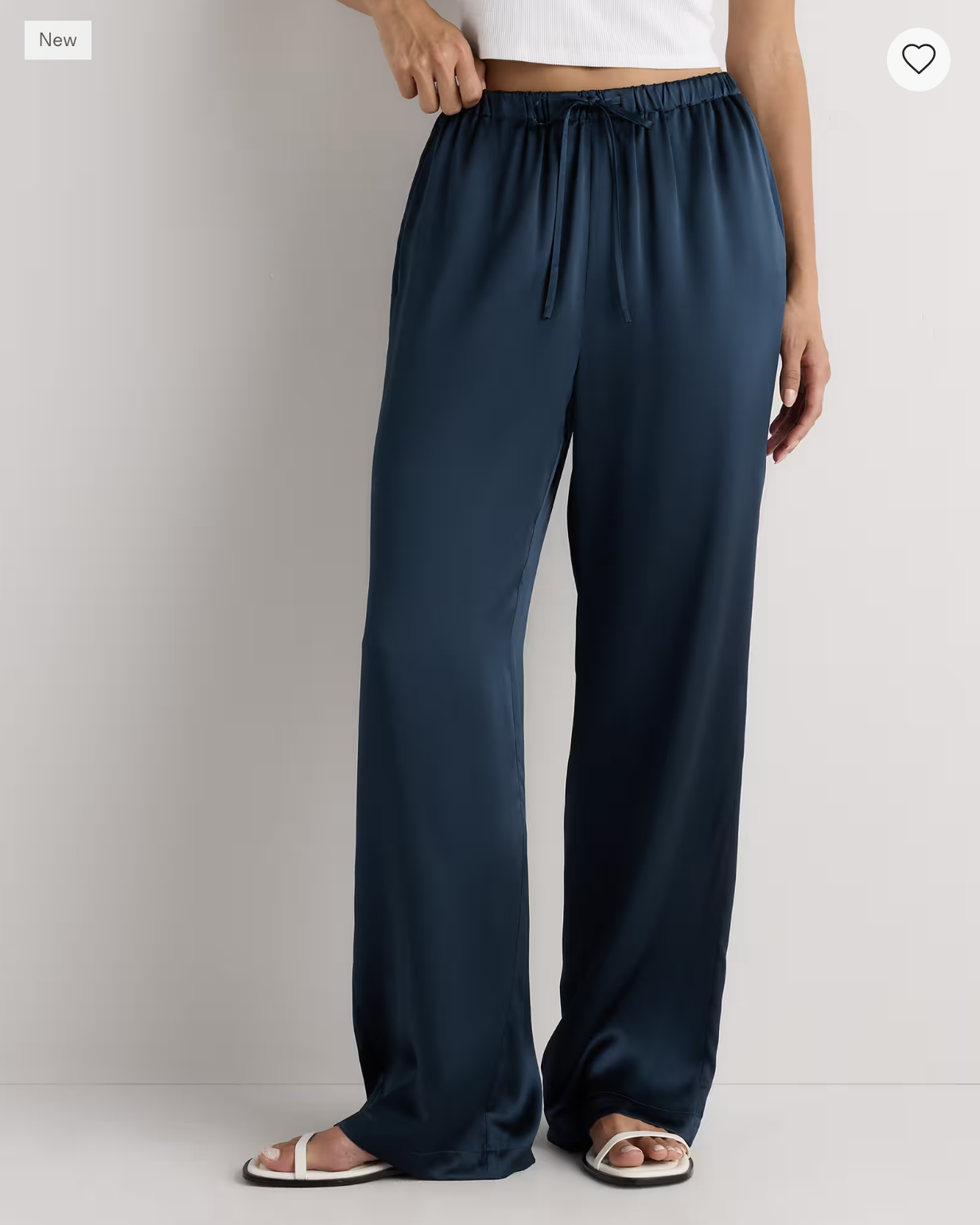 Quince Washable Silk Drawstring Wide-Leg Pants in navy, styled with a white tank and flat sandals.