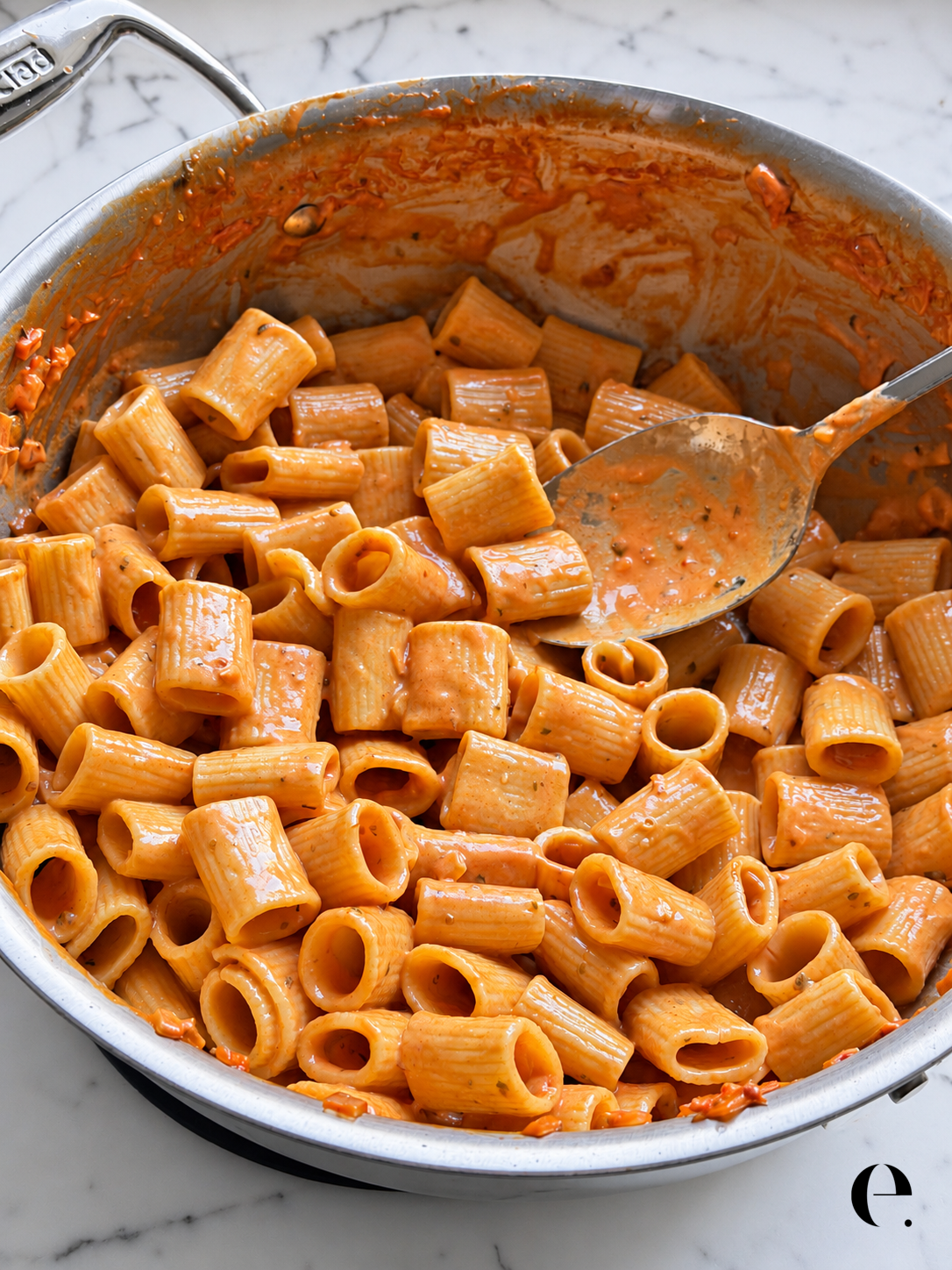 Quick pasta alla vodka coated in creamy tomato sauce with grated Parmesan