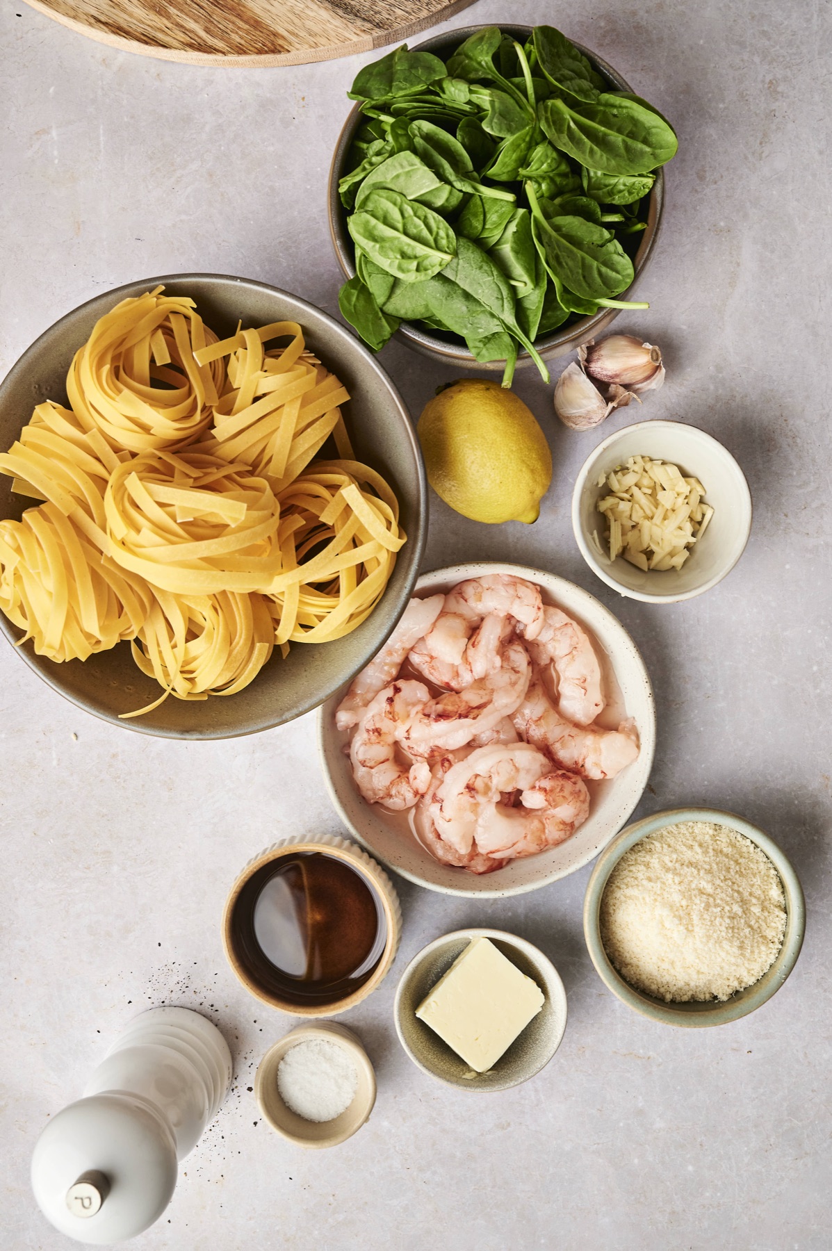 Ingredients for lemon garlic shrimp pasta: pasta, shrimp, spinach, garlic, lemon, butter and Parmesan