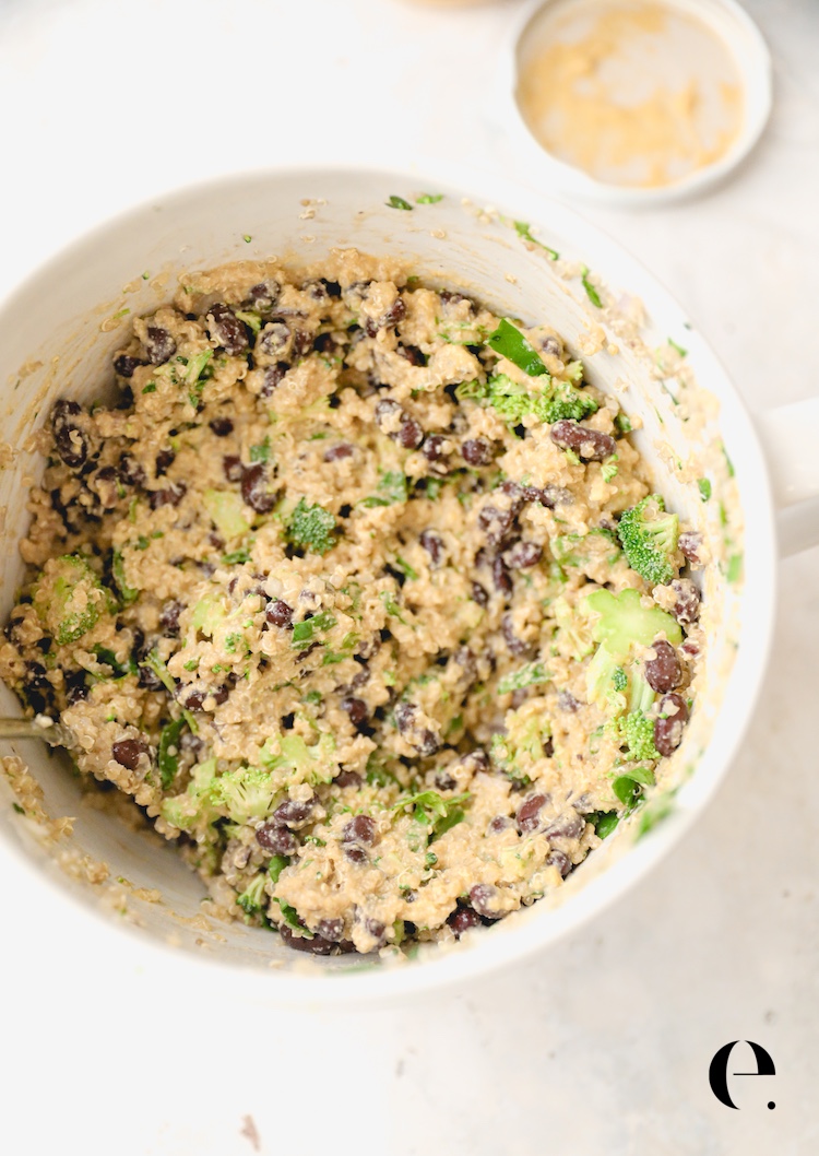 Quinoa and black bean stuffed pepper filling mixed with nacho cheese sauce in a white bowl