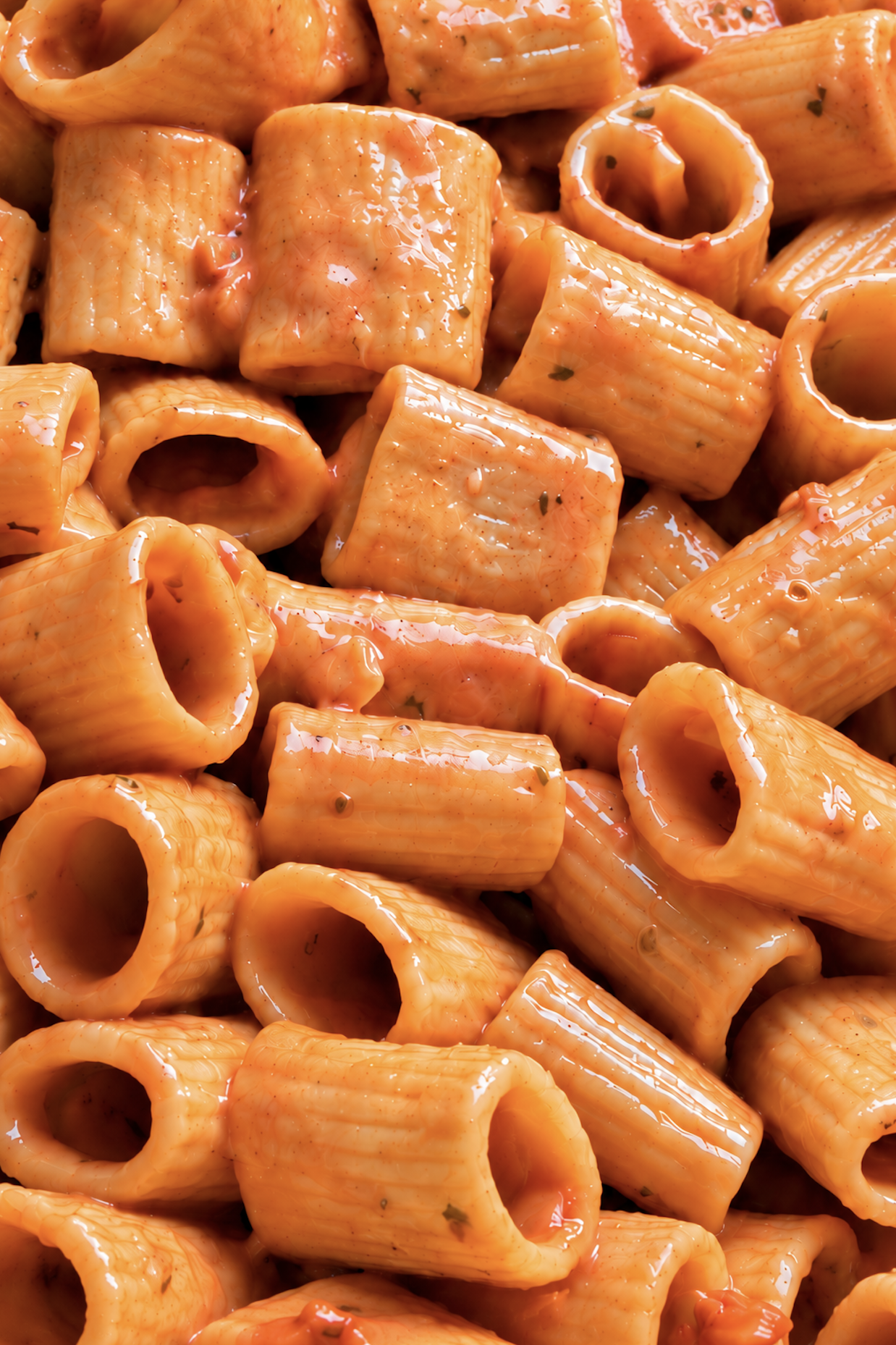 very close up vodka pasta with glossy tomato sauce